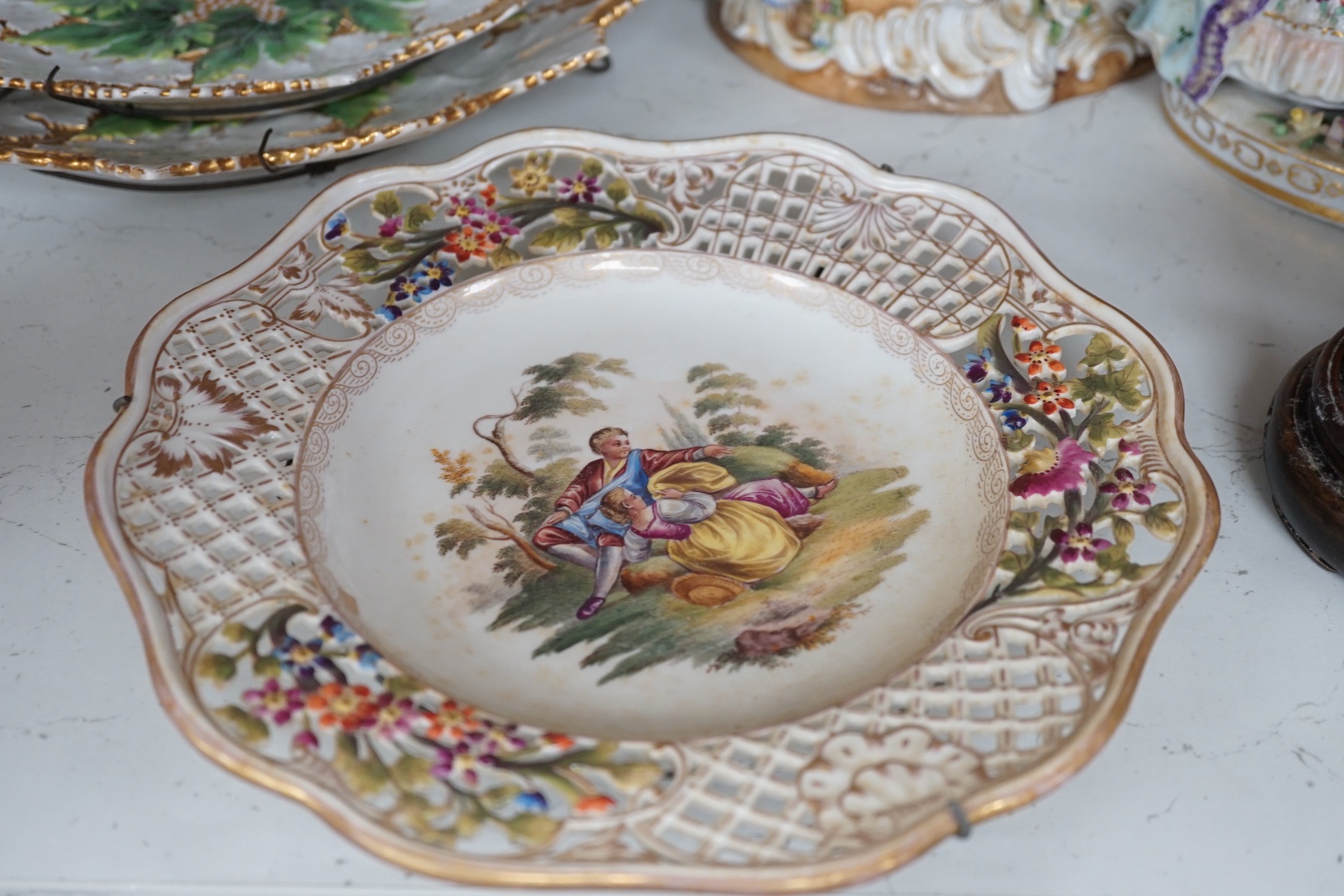 Two Meissen leaf dishes, a Dresden plate, two group figures and mixed ceramics, tallest 25cms high